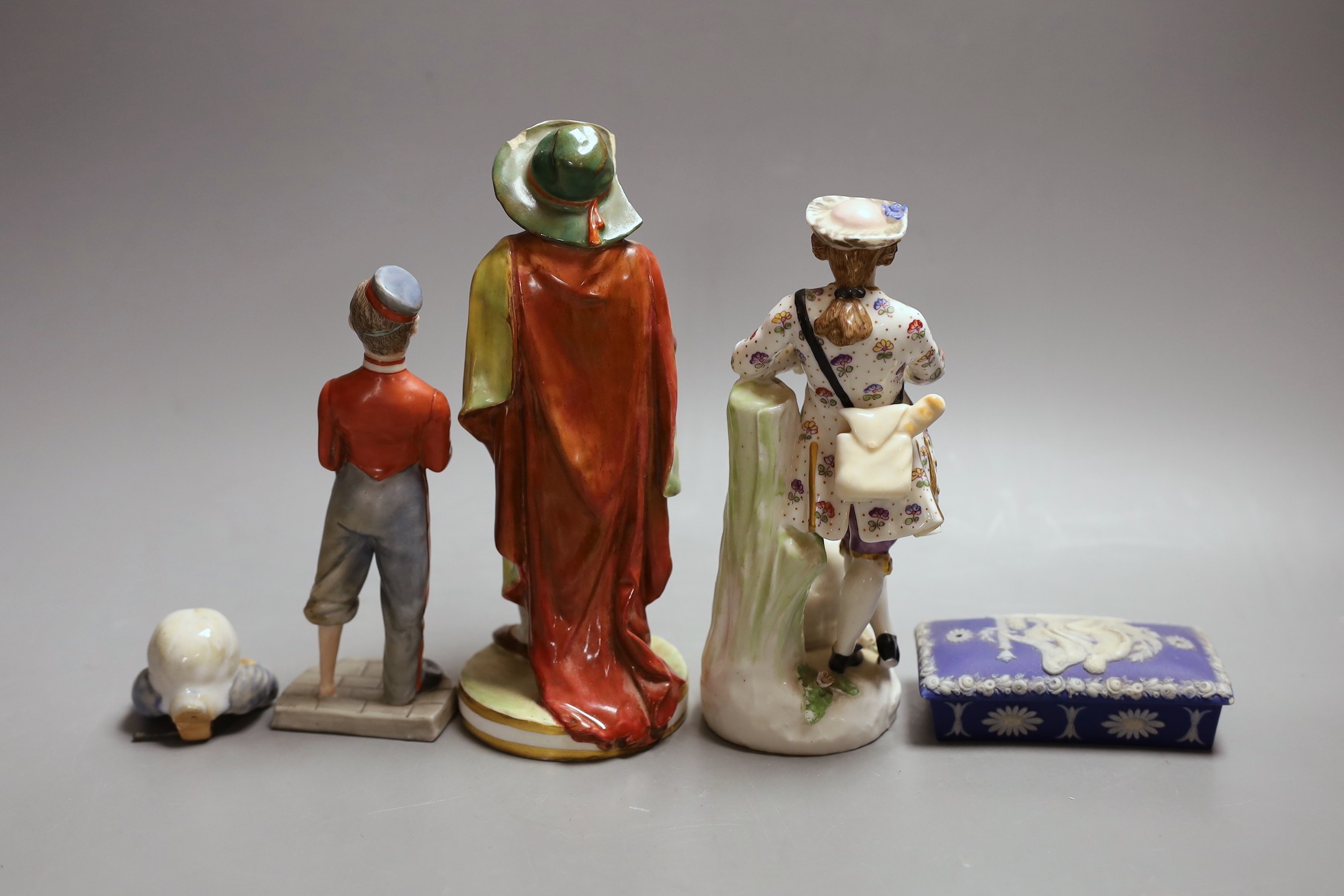 A Crown Derby figure, 19.5cm, a Royal Worcester figure of an amputee, a continental porcelain group, the cover from a Doulton votes for women inkwell and a box and cover